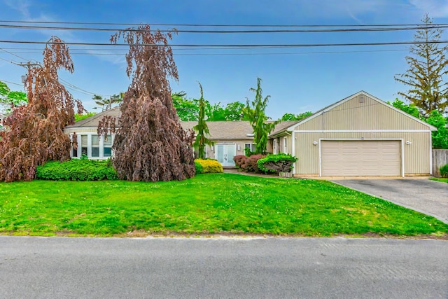 11 Woodside Ave, Islip, NY 11751 - view of front of home with driveway, an attached garage, and a front yard