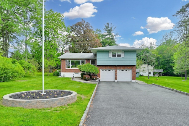 tri-level home with brick siding, an attached garage, a chimney, and driveway