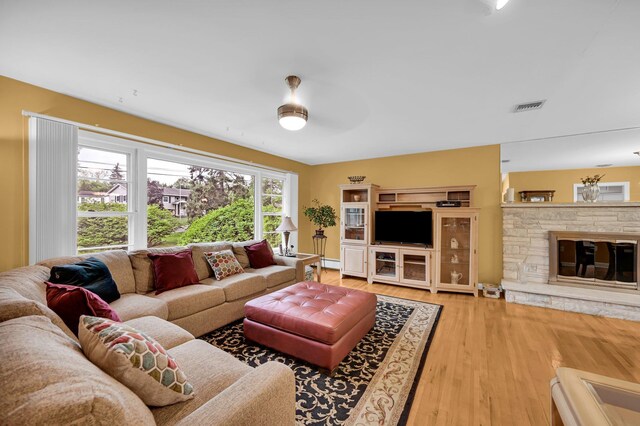 living room with wood finished floors and a fireplace