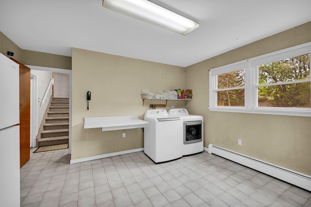 laundry room with a baseboard radiator, independent washer and dryer, and baseboards