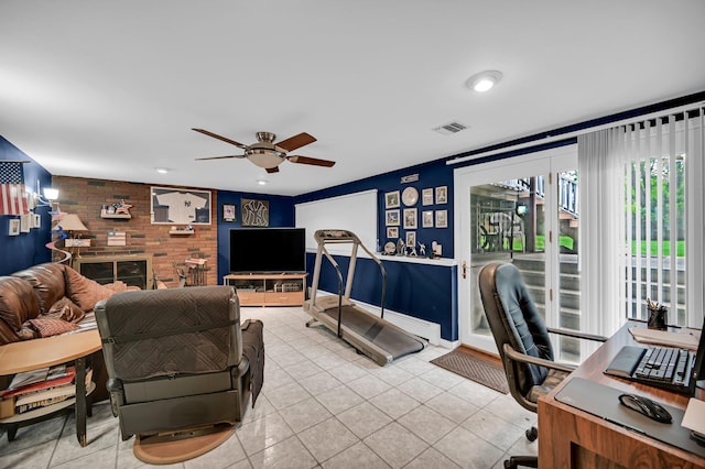 living area with ceiling fan, light tile patterned floors, and a desk