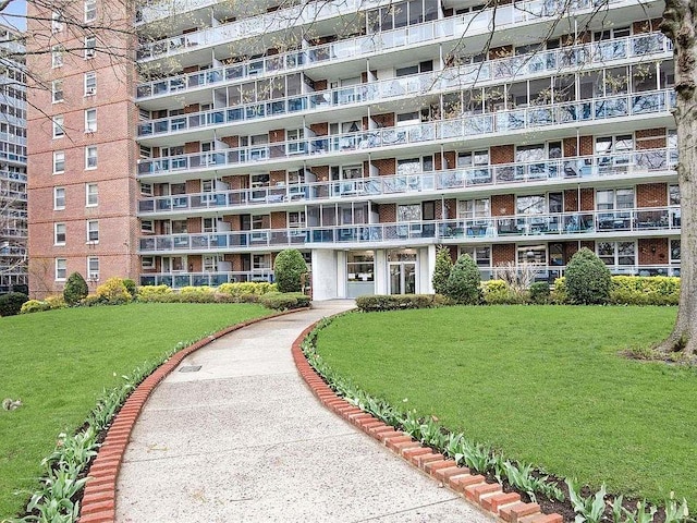 view of property's community with a lawn