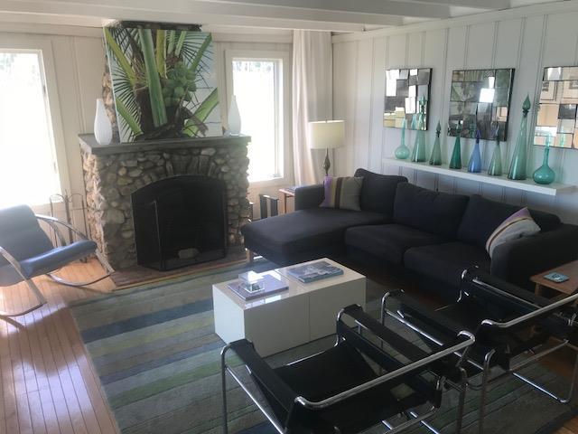 209 Bayview Walk, Cherry Grove, NY 11782 - living room featuring wood-type flooring, a decorative wall, a fireplace, and beamed ceiling