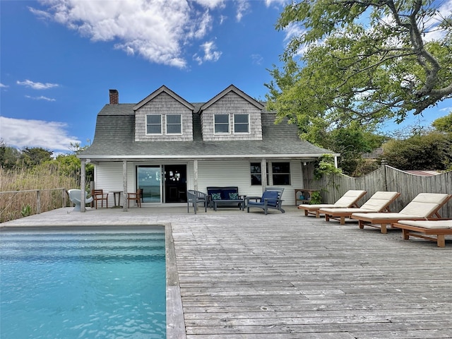 209 Bayview Walk, Cherry Grove, NY 11782 - back of property featuring a wooden deck, a chimney, a shingled roof, and outdoor lounge area