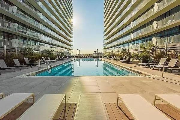 40-26 College Point Blvd Unit 8M, Flushing, NY 11354 - community pool with a patio