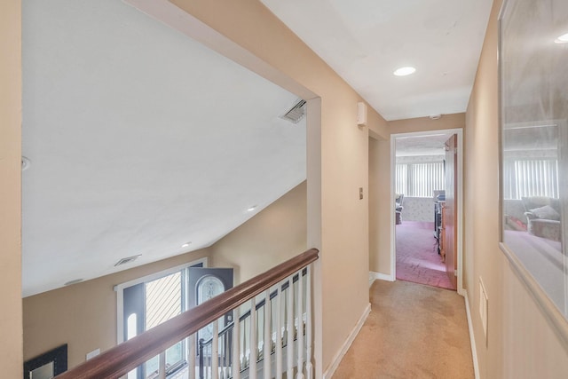 12 Grand Canyon Ln, Coram, NY 11727 - hallway featuring light colored carpet, healthy amount of natural light, baseboards, and an upstairs landing