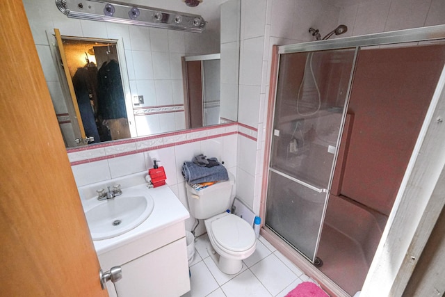 12 Grand Canyon Ln, Coram, NY 11727 - bathroom with tile walls, a shower stall, vanity, tile patterned flooring, and toilet