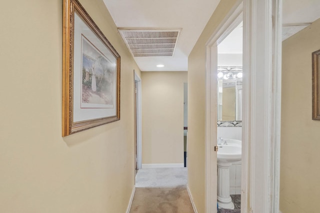12 Grand Canyon Ln, Coram, NY 11727 - hallway with baseboards and light carpet