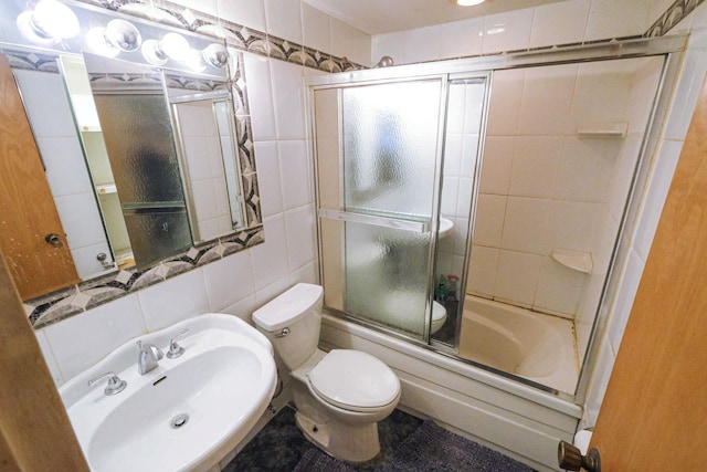 12 Grand Canyon Ln, Coram, NY 11727 - full bath featuring a sink, enclosed tub / shower combo, tile walls, and toilet