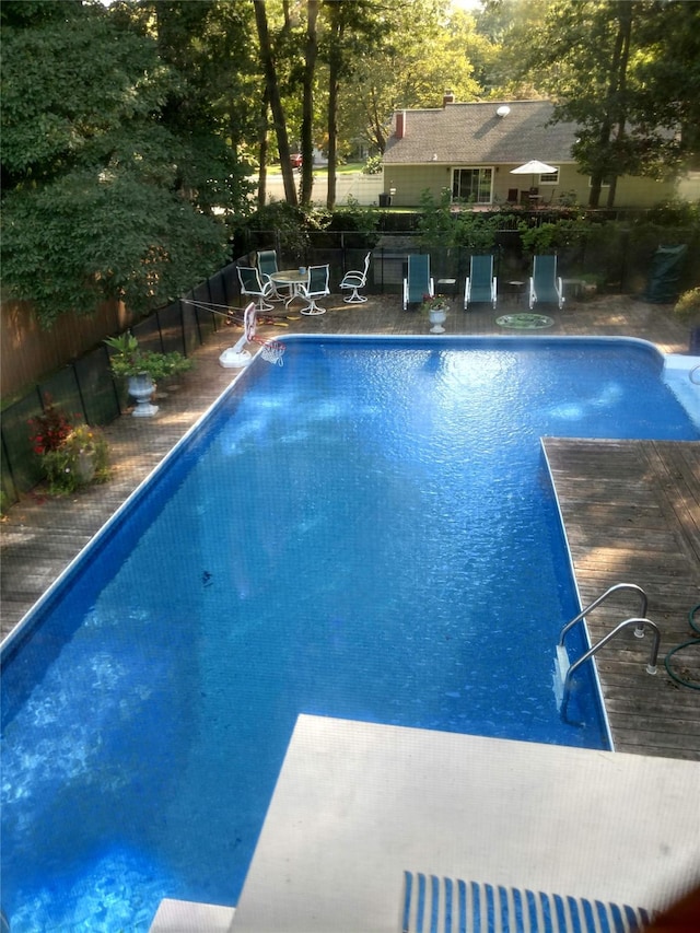 12 Grand Canyon Ln, Coram, NY 11727 - view of pool featuring fence, a diving board, and view of scattered trees