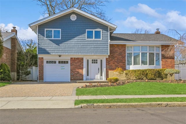 1841A Decatur Ave, Bellmore, NY 11710 - tri-level home with brick siding, a garage, decorative driveway, and a chimney