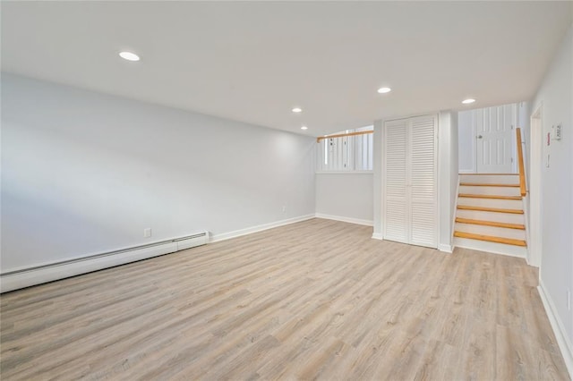 1841A Decatur Ave, Bellmore, NY 11710 - below grade area with a baseboard heating unit, baseboards, light wood-style floors, recessed lighting, and stairway