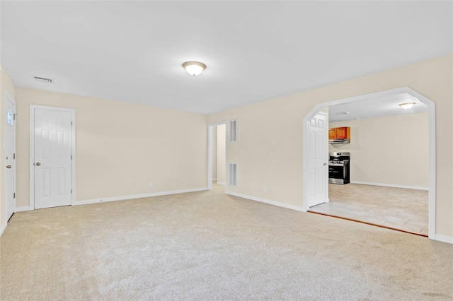 97 Overlook Dr, Mastic Beach, NY 11951 - spare room with light colored carpet, baseboards, and arched walkways