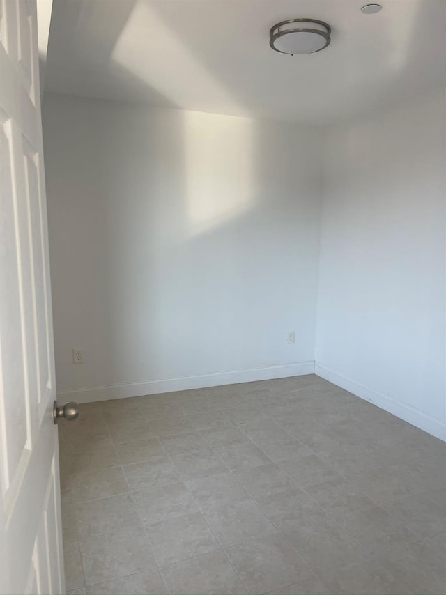 empty room featuring baseboards