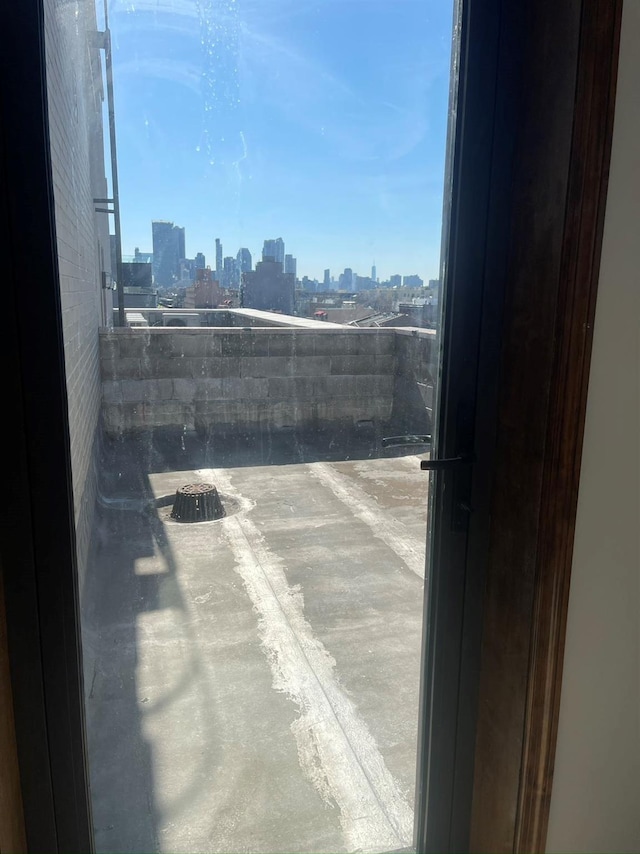view of patio / terrace with a view of skyline and a balcony