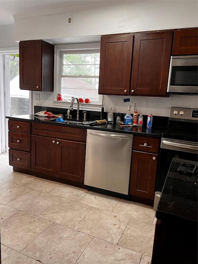 97 Hungry Harbor Rd, Valley Stream, NY 11581 - kitchen featuring appliances with stainless steel finishes, crown molding, dark countertops, a sink, and dark brown cabinetry
