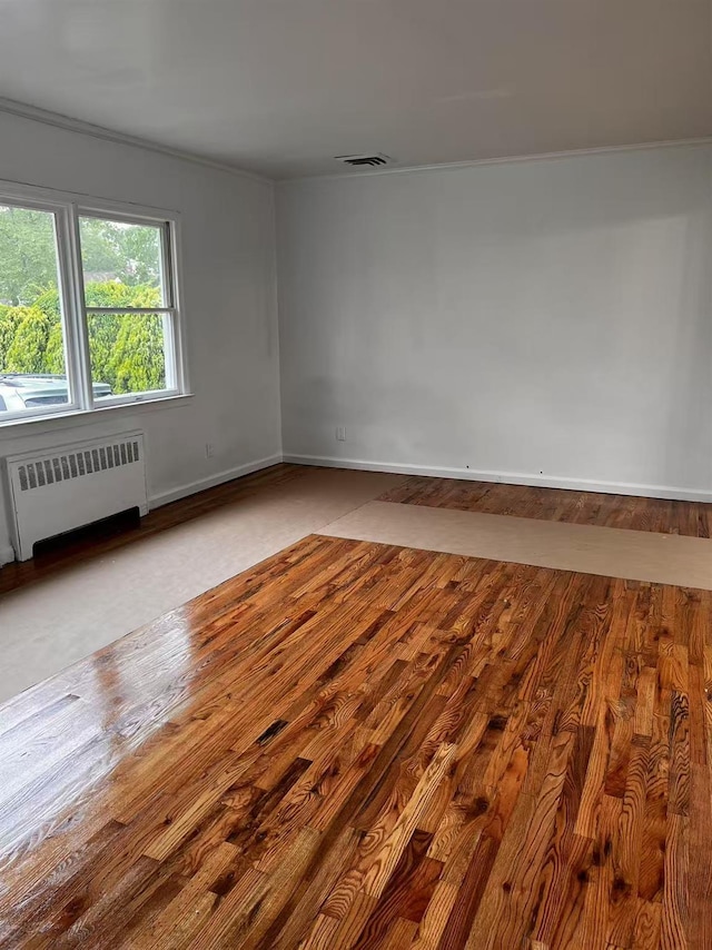 97 Hungry Harbor Rd, Valley Stream, NY 11581 - empty room with radiator, baseboards, crown molding, and wood finished floors