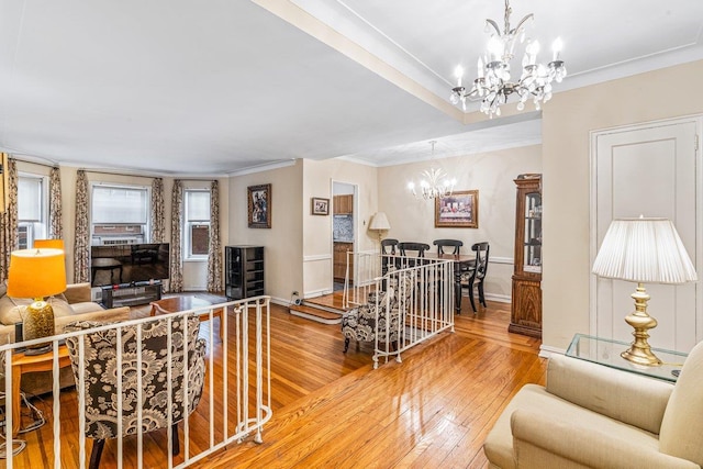 76-36 113th St Unit 1A, Forest Hills, NY 11375 - living room with a chandelier, wood-type flooring, crown molding, and baseboards