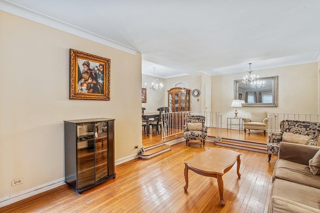 76-36 113th St Unit 1A, Forest Hills, NY 11375 - living area with a chandelier, light wood finished floors, ornamental molding, and baseboards