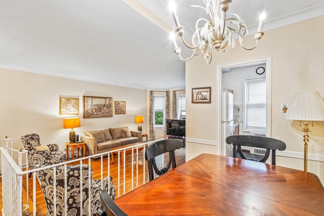 76-36 113th St Unit 1A, Forest Hills, NY 11375 - dining space with a chandelier, baseboards, crown molding, and wood finished floors
