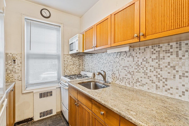 76-36 113th St Unit 1A, Forest Hills, NY 11375 - kitchen featuring white appliances, a sink, radiator, backsplash, and dark tile patterned floors