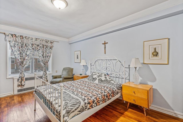 76-36 113th St Unit 1A, Forest Hills, NY 11375 - bedroom featuring radiator, hardwood / wood-style floors, baseboards, and ornamental molding