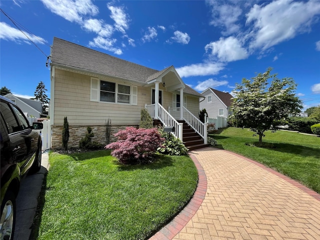 3168 Yost Blvd, Oceanside, NY 11572 - view of front of property with a front lawn, stone siding, and a shingled roof