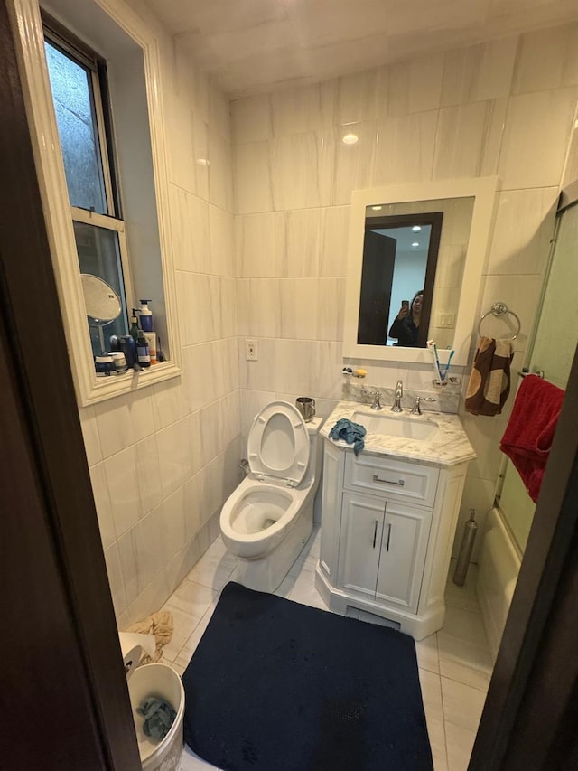 74-45 Yellowstone Blvd Unit 2A, Forest Hills, NY 11375 - full bathroom featuring tile walls, tile patterned flooring, vanity, and toilet