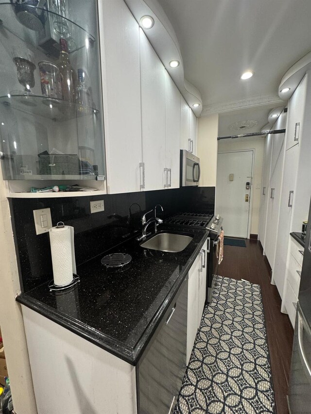 74-45 Yellowstone Blvd Unit 2A, Forest Hills, NY 11375 - kitchen with appliances with stainless steel finishes, a sink, white cabinets, dark wood-type flooring, and dark countertops