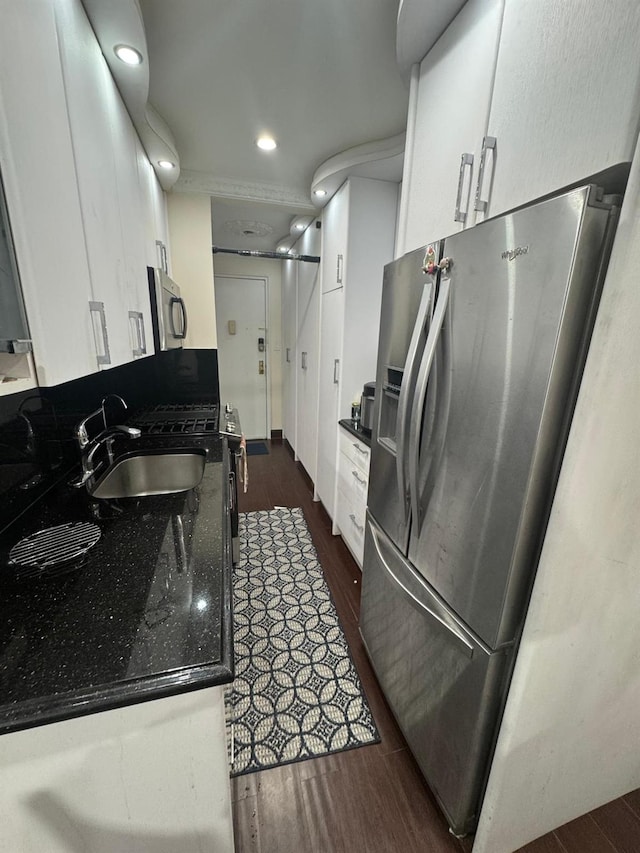 74-45 Yellowstone Blvd Unit 2A, Forest Hills, NY 11375 - kitchen featuring stainless steel appliances, dark wood-style floors, white cabinets, dark countertops, and a sink