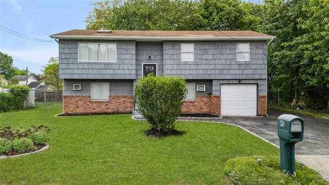 40 S 29th St, Wyandanch, NY 11798 - raised ranch with brick siding, asphalt driveway, and a garage