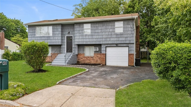 40 S 29th St, Wyandanch, NY 11798 - bi-level home with asphalt driveway, a front lawn, and brick siding