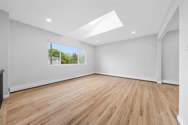 40 S 29th St, Wyandanch, NY 11798 - unfurnished room featuring wood finished floors, a skylight, recessed lighting, baseboards, and baseboard heating