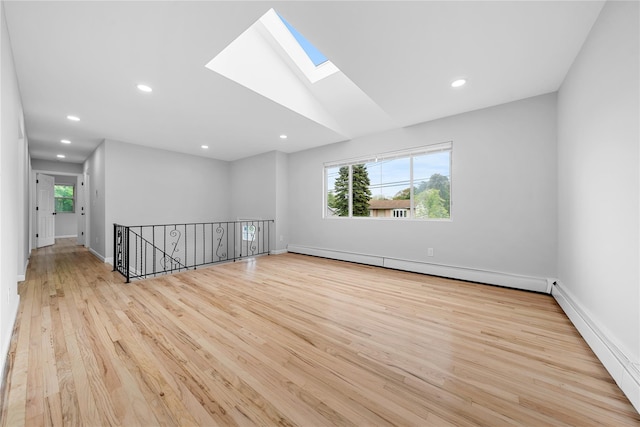40 S 29th St, Wyandanch, NY 11798 - unfurnished room with a skylight, wood finished floors, recessed lighting, a baseboard heating unit, and baseboards