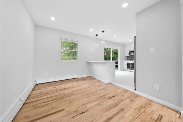 40 S 29th St, Wyandanch, NY 11798 - spare room featuring light wood-style floors, recessed lighting, a baseboard heating unit, and baseboards