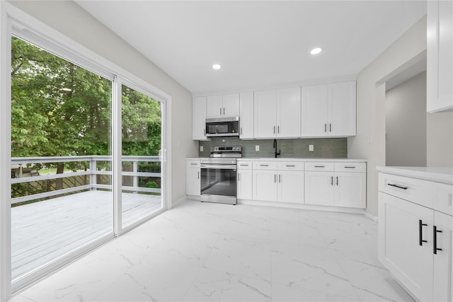 40 S 29th St, Wyandanch, NY 11798 - kitchen with stainless steel appliances, light marble finish floors, light countertops, baseboards, and recessed lighting