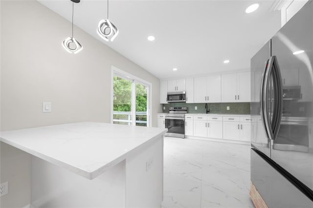40 S 29th St, Wyandanch, NY 11798 - kitchen featuring stainless steel appliances, light marble finish flooring, recessed lighting, white cabinets, and light stone countertops