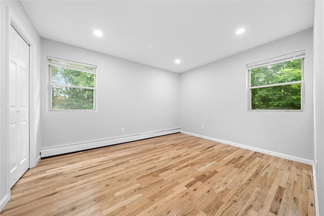 40 S 29th St, Wyandanch, NY 11798 - unfurnished bedroom with a baseboard radiator, multiple windows, light wood-style flooring, recessed lighting, and baseboards