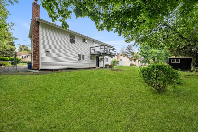 40 S 29th St, Wyandanch, NY 11798 - rear view of property featuring a chimney, a wooden deck, and an outbuilding