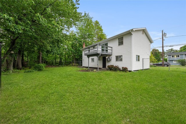 40 S 29th St, Wyandanch, NY 11798 - back of house with a chimney and a wooden deck