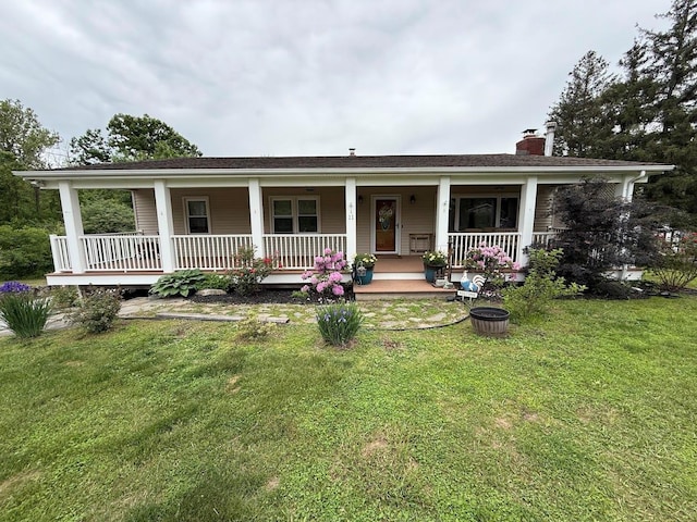 11 Queen Anne Ln, Wappingers Falls, NY 12590 - view of front of property with a chimney, covered porch, and a front yard