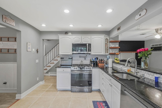 121 Tyler Ave, Miller Place, NY 11764 - kitchen featuring appliances with stainless steel finishes, a sink, tasteful backsplash, white cabinetry, and recessed lighting