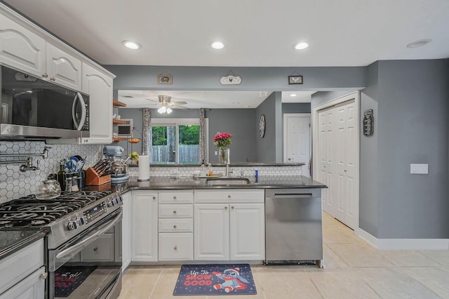 121 Tyler Ave, Miller Place, NY 11764 - kitchen with stainless steel appliances, a peninsula, a sink, a ceiling fan, and light tile patterned flooring