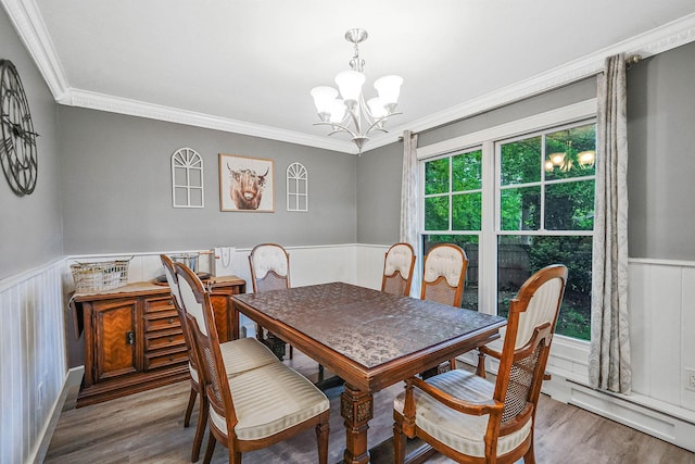 121 Tyler Ave, Miller Place, NY 11764 - dining area featuring a wainscoted wall, a chandelier, wood finished floors, and ornamental molding