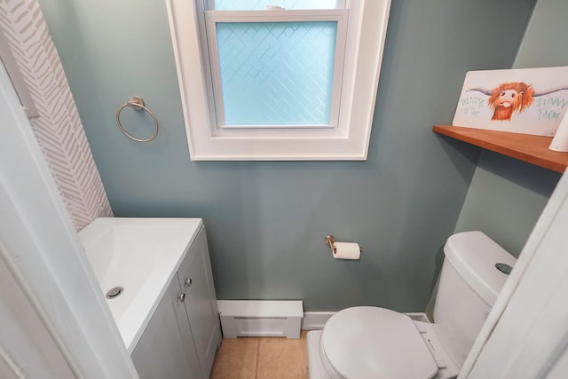 121 Tyler Ave, Miller Place, NY 11764 - half bath with a baseboard radiator, toilet, vanity, tile patterned floors, and healthy amount of natural light