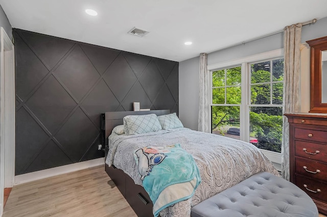 121 Tyler Ave, Miller Place, NY 11764 - bedroom with an accent wall, light wood finished floors, a decorative wall, recessed lighting, and baseboards