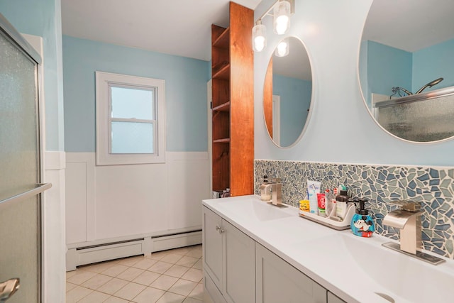 121 Tyler Ave, Miller Place, NY 11764 - full bath with baseboard heating, wainscoting, tile patterned floors, double vanity, and an enclosed shower