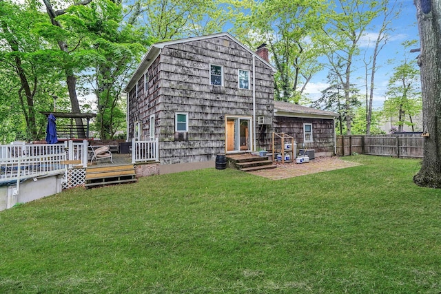 121 Tyler Ave, Miller Place, NY 11764 - rear view of property with a chimney and a wooden deck
