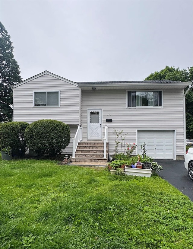 113 6th Ave, Huntington Station, NY 11746 - bi-level home featuring entry steps, an attached garage, asphalt driveway, and a front yard