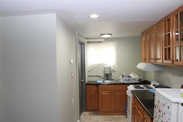 113 6th Ave, Huntington Station, NY 11746 - kitchen featuring electric stove, brown cabinetry, ventilation hood, dark countertops, and refrigerator